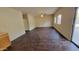 Living room featuring dark brown laminate flooring and lots of natural light at 9202 W Cambridge Ave, Phoenix, AZ 85037