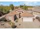 Single-story home with tile roof, desert landscaping, and two-car garage at 1134 E Jahns Dr, Casa Grande, AZ 85122