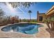 Inviting kidney-shaped pool with a waterfall feature, surrounded by a spacious patio at 13037 E Jenan Dr, Scottsdale, AZ 85259