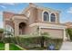 Two-story house with tan exterior, arched windows, and a two-car garage at 1321 W Clear Spring Dr, Gilbert, AZ 85233