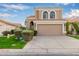 Two-story house with tan exterior, arched windows, and a two-car garage at 1321 W Clear Spring Dr, Gilbert, AZ 85233