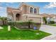 Two-story house with tan exterior, arched windows, and a two-car garage at 1321 W Clear Spring Dr, Gilbert, AZ 85233