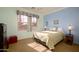 Bright bedroom with double bed, window, and nightstands at 13414 W Micheltorena Dr, Sun City West, AZ 85375