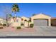 Single-story home with desert landscaping and a two-car garage at 13414 W Micheltorena Dr, Sun City West, AZ 85375