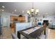 Open concept kitchen and dining area with breakfast bar and view to living room at 13414 W Micheltorena Dr, Sun City West, AZ 85375
