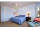 Main bedroom with king-size bed and golf course views at 13414 W Micheltorena Dr, Sun City West, AZ 85375