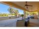 Spacious covered patio with seating area and golf course view at 13414 W Micheltorena Dr, Sun City West, AZ 85375