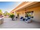 Covered patio with comfortable seating and ceiling fan at 13414 W Micheltorena Dr, Sun City West, AZ 85375