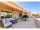 Spacious covered patio with seating area and view of the backyard at 13414 W Micheltorena Dr, Sun City West, AZ 85375