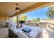 Relaxing covered patio with outdoor furniture and golf course view at 13414 W Micheltorena Dr, Sun City West, AZ 85375