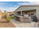 Outdoor kitchen, spa, and fire pit in a landscaped backyard at 14196 W Gray Fox Trl, Surprise, AZ 85387