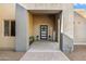 Modern entryway with a black door, lanterns, and a welcome sign at 14315 E Skinner Dr, Scottsdale, AZ 85262