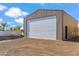 Large metal workshop building with a white roll up door at 14315 E Skinner Dr, Scottsdale, AZ 85262