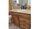 Bathroom with granite countertop and wood cabinets at 16828 N 107Th Dr, Sun City, AZ 85351