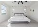 Main bedroom with gray bed, ceiling fan, and plenty of natural light at 17329 W Gretna St, Surprise, AZ 85388