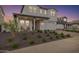 Two story home with front porch and landscaped yard at 17329 W Gretna St, Surprise, AZ 85388