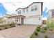 Two story home with front porch and landscaped yard at 17329 W Gretna St, Surprise, AZ 85388