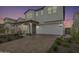 Two story home with front yard landscaping and a paved driveway at 17329 W Gretna St, Surprise, AZ 85388