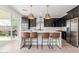Modern kitchen with white countertops, dark cabinets, and a breakfast bar at 17329 W Gretna St, Surprise, AZ 85388