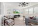 Bright living room with hardwood floors, a large TV, and comfy seating at 17329 W Gretna St, Surprise, AZ 85388