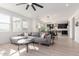 Bright living room with gray sectional sofa and an open floor plan at 17329 W Gretna St, Surprise, AZ 85388