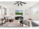Bright living room with hardwood floors, a large TV, and comfy seating at 17329 W Gretna St, Surprise, AZ 85388