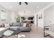 Open living room features a gray sectional sofa, coffee table, and views into the kitchen at 17329 W Gretna St, Surprise, AZ 85388