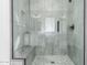 Modern shower with glass enclosure and pebble-stone floor at 17329 W Gretna St, Surprise, AZ 85388