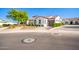 Single story home with Spanish-style architecture,landscaped yard and two-car garage at 17379 W Guthrie St, Surprise, AZ 85388