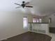 Living room featuring dark hardwood floors, built-in shelving and a ceiling fan at 17447 W Rock Wren Ct, Goodyear, AZ 85338