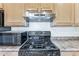 Gas cooktop with stainless steel range hood in the kitchen at 2949 W Kristina Ave, San Tan Valley, AZ 85144