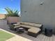 Relaxing backyard patio with sectional sofa, fire pit, and grassy area at 4856 S Tune --, Mesa, AZ 85212