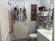 Clean bathroom with a toilet, shower, and storage shelving at 4856 S Tune --, Mesa, AZ 85212