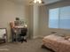 Bright bedroom with a bed, desk, and large window with blinds at 4856 S Tune --, Mesa, AZ 85212