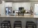 Spacious kitchen with granite countertops, white cabinets, and an island with seating at 4856 S Tune --, Mesa, AZ 85212