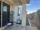 Small patio with two blue chairs, a table and a dog house at 4856 S Tune --, Mesa, AZ 85212
