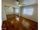 Bedroom with wood flooring, mirrored closet doors, and a window at 4901 S Calle Los Cerros Dr # 202, Tempe, AZ 85282
