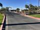Gated community entrance with paved road and landscaping at 4901 S Calle Los Cerros Dr # 202, Tempe, AZ 85282