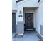 Modern front door with a fall-themed wreath and potted plants at 5311 W San Gabriel Ave, Phoenix, AZ 85339