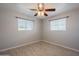 Bright bedroom with tile floors and two windows at 5914 E Decatur St, Mesa, AZ 85205