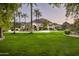 Elegant estate home with lush landscaping, a long driveway, and mountain views at 6161 N 59Th Pl, Paradise Valley, AZ 85253