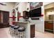 Garage bar with granite countertop, custom cabinetry, and bar stools at 6161 N 59Th Pl, Paradise Valley, AZ 85253