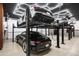 Modern garage with a car lift system for multiple vehicles at 6161 N 59Th Pl, Paradise Valley, AZ 85253