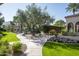 Curved garden path with lush landscaping and a view of tennis court at 6161 N 59Th Pl, Paradise Valley, AZ 85253