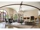 Grand living room with high ceilings, a large chandelier, and ornate fireplace at 6161 N 59Th Pl, Paradise Valley, AZ 85253