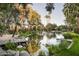 Picturesque pond with a wooden footbridge, arches, and tranquil water features at 6161 N 59Th Pl, Paradise Valley, AZ 85253