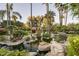 Landscaped backyard oasis featuring a serene pond and lush greenery at 6161 N 59Th Pl, Paradise Valley, AZ 85253
