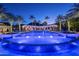 Stunning pool and patio area at night with lights and palm trees at 6161 N 59Th Pl, Paradise Valley, AZ 85253