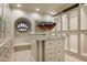 Custom walk-in closet with island and glass-front cabinets at 6161 N 59Th Pl, Paradise Valley, AZ 85253
