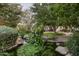 Peaceful water feature with lush landscaping and stone accents at 6161 N 59Th Pl, Paradise Valley, AZ 85253